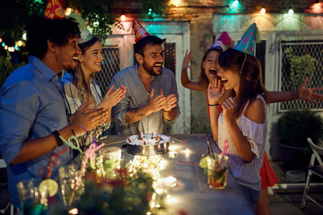 A group of happy friends congratulate the birthday to celebrant at a open air party. Quality friendship time together