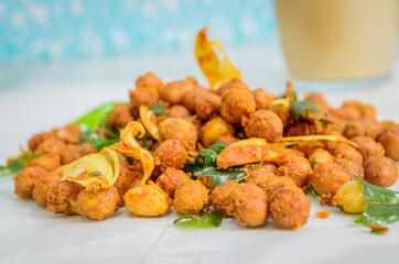 Macro shot of Deep Fried Masala Peanuts with Garlic & Curry Leaves.
