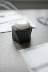 extinguished candle in a concrete candle holder