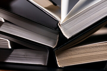 Open books are arranged in an overlapping way. Vertical position.