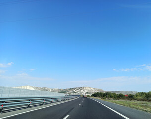 Fototapeta premium Asphalt road along the sea at sunset.