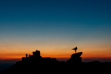 Naklejka premium Karate athlete fighting practicing karate at sunset