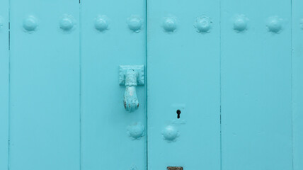 colored wooden doors with metal knobs