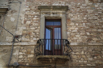 Ancient window in a house of the medieval city of Todi