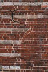 red brick wall with old door arch