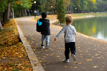 Children running along the path in the park