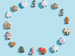 Blue Christmas advertising background. Cookie pattern round frame. Winter holidays bakery food decor. Homemade gingerbread biscuit collection arrangement isolated on light copy space.