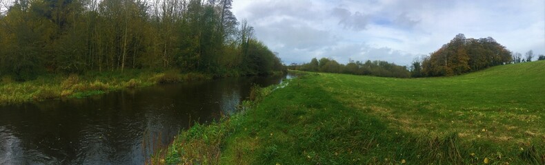 River, meadow and trees in late autumn