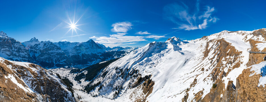 Winter landscape with snow covered peaks seen from the First mountain in Swiss Alps in Grindelwald, Switzerland