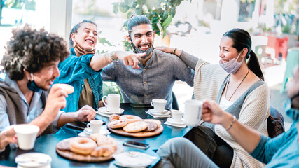 People having fun drinking and eating at coffeehouse - Young friends talking together at restaurant cafeteria - New normal lifestyle concept with happy guys and girls at cafe bar - Bright azure filter