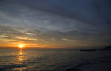 Fototapeta na wymiar Pierce at beach sea at sunset in Loo village, Sochi, Krasnodar Region, Russia