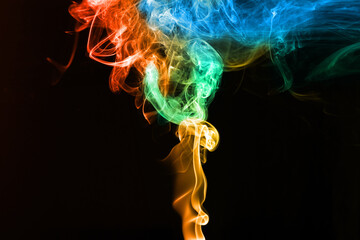 Abstract color smoke swirls on a black background.