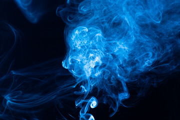 Abstract blue smoke swirls on a black background...