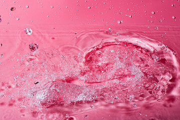 splash of water on a red background. Abstract wallpaper