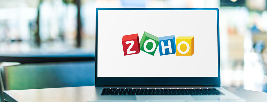 Laptop computer displaying logo of Zoho