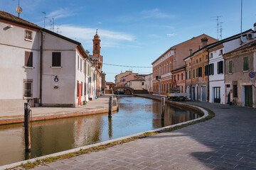 Fototapeta na wymiar Comacchio, Ferrara / Italy - August 2020: View of the historic center of Comacchio with its main canal, sky with clouds