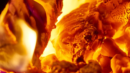 Close up shot of burning firewood in the fireplace. low light