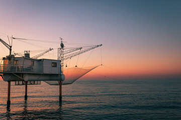 Marina di Ravenna, Ravenna / Italy - August 2020: Molo Zaccagnini during the sunrise