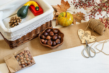Halloween pumpkins, nuts and craft handmade things, beauty gift package concept. Presents packed in craft gif box, zero waste life style.