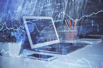 Double exposure of chart and financial info and work space with computer background. Concept of...