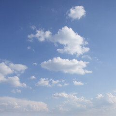 Soft white clouds in the blue sky. Sky background.