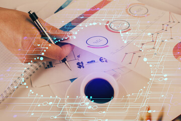 Writing man's hand with technology icons.
