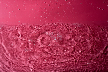 splash of water on a red background. Abstract wallpaper