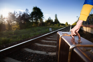 Not a safe walk on the tracks with an old travel suitcase at sunset on hot summer days.