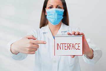 Writing note showing Interface. Business concept for the means by which interaction or...