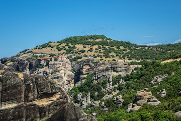 Naklejka premium Rock cliffs (60 million years old) in deltaic plains of Meteora. Cliffs rise to a height of 400 meters. They situated in Pineios Valley within Thessalian plains close to town of Kalambaka. Greece.