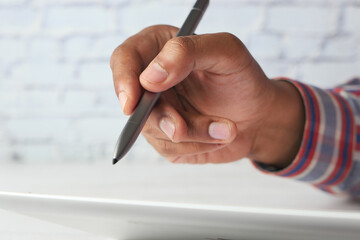 man's hand working on digital tablet on office desk 