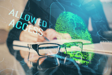 Blue fingerprint hologram over woman's hands taking notes background. Concept of protection. Double...