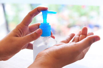 women hand using sanitizer gel for preventing virus with copy space 
