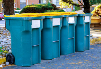 Recycling bins at a separate recycling garbage trash for waste segregation near the entrance to the house.