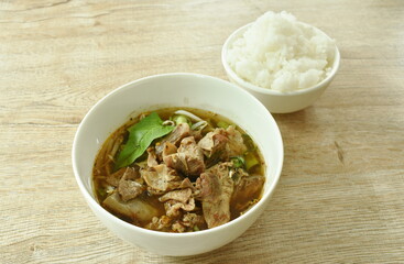 boiled braised pork with liver and morning glory in brown herb soup on bowl eat couple plain rice cup