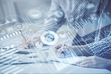 Technology theme hologram with man working on computer on background. High tech concept. Double exposure.