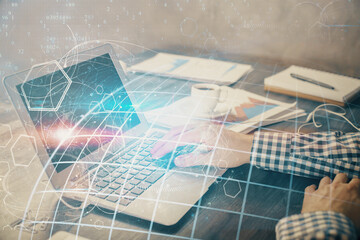 Fototapeta premium Multi exposure of world map hologram with man working on computer on background. Concept of worldwideweb.