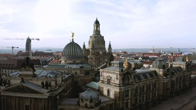 Drone footage of Dresden inner city with Frauenkirche, Drone footage of golden Fama figure statue on top of Zitronenpresse with Frauenkirche in background in Dresden, Germany