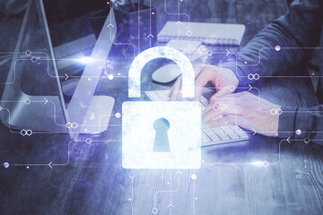 Double exposure of lock icon with man working on computer on background. Concept of network security.