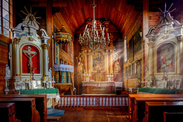 Fototapeta na wymiar an altar in a historic wooden church and the rays of the sun