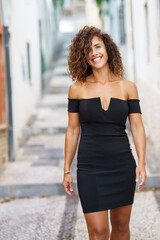 Beautiful brunette middle-aged woman wearing dress outdoors