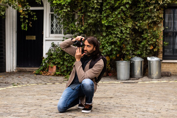Portrait of a male photographer who is taking photos in a small alley in London, United Kingdom