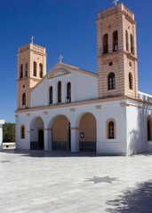 Fototapeta na wymiar Naxos, Greece - August 18 2016:Modern church in Naxos Island, white and orange coloured