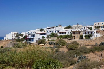 Fototapeta na wymiar row of houses in Naxos Island through fields