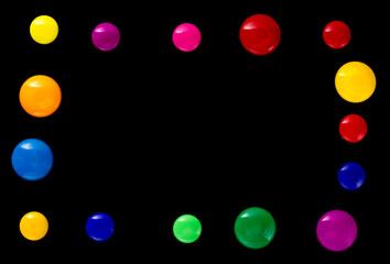 background frame made of colored magnetic paper clips on black background