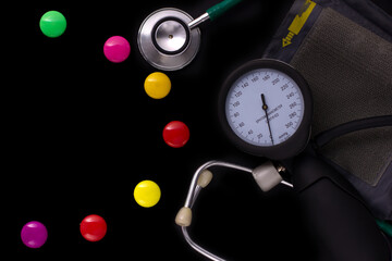 medical tonometer, background frame made of colored magnetic paper clips on black background with space for text