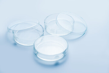 Transparent glass Petri dishes on blue background, Biology laboratory glassware