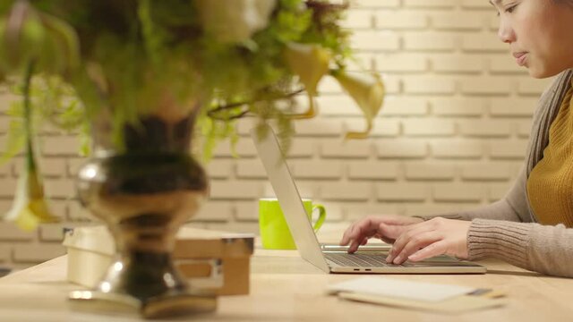 Attractive Asian female woman casual cloth using desktop computer work at home  Work at home lifestyle or self isolation remote working while spread of coronavirus epidemic