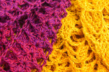 handmade multicolor crochet background in  yellow, orange, pink and purple with double crochet stitches