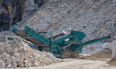 Mobile gravel crusher in a marble quarry. Rock crushing plant. Sand and gravel equipment manufacturer.